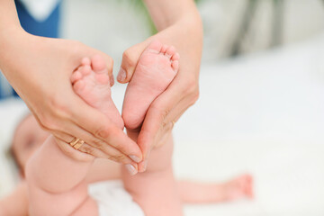 Close-up of children's foot massage on the bed.