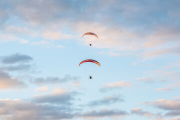 paragliders high in the sky above the ground