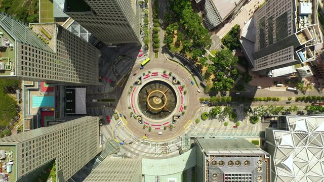 Drone Aerial view 4k Footage of Singapore landmark financial business district with skyscraper. Fountain of Wealth at Suntec city in Singapore. Motion circle of traffic in center