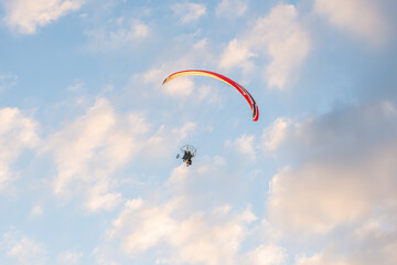 paragliders high in the sky above the ground