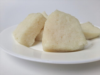 Wajik ketan, is a traditional snack from Indonesia. Made from sticky rice. On a white plate, isolated in white background.