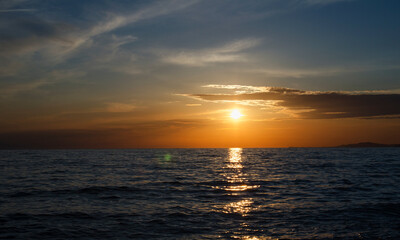 A warm sunset over the sea horizon.