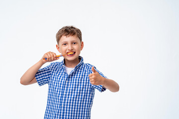 Happy 7-year-old Caucasian boy, smiling, brushing his teeth