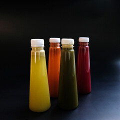 Fruit juice in a bottle on a Black background