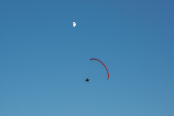 paragliders high in the sky above the ground
