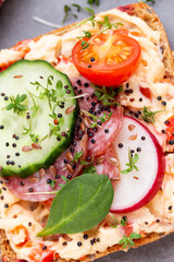 Sandwiches with cream cheese, vegetables and salami.