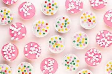 Colorful cupcakes on a white background.