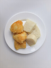 Wajik ketan, is a traditional snack from Indonesia, before and after fried. Made from sticky rice. On a white plate, isolated in white background.