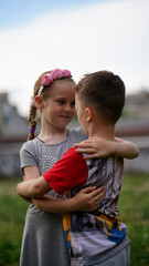 Cute little girl and boy hugging each other