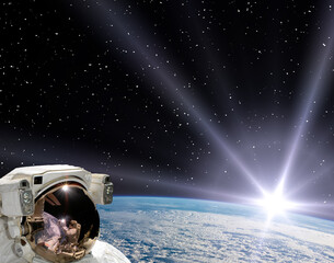 Fototapeta na wymiar Astronaut and sunrise. The elements of this image furnished by NASA.