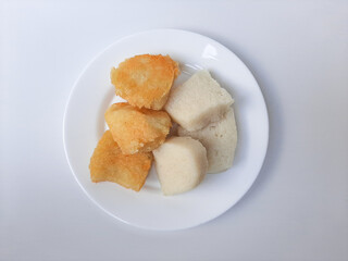 Wajik ketan, is a traditional snack from Indonesia, before and after fried. Made from sticky rice. On a white plate, isolated in white background.