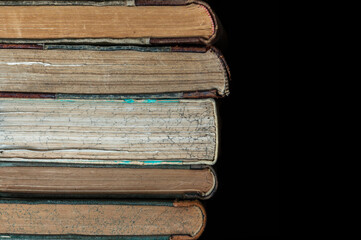 stack of old books on a library shelf