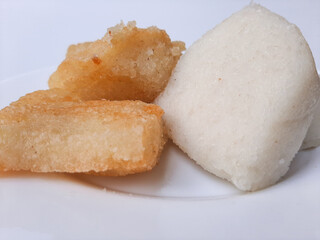 Jadah ketan, is a traditional snack from Indonesia. Made from sticky rice and grated coconut. Comparison before and after fried. On a white plate, isolated in white background