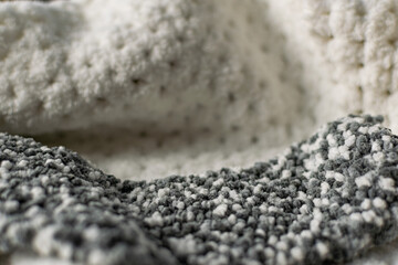 Fine textured and voluminous fabric in white and gray. Embossed textile pattern, pleasant to the touch and delicate, velvety and textured background for design and decoration.