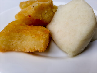 Jadah ketan, is a traditional snack from Indonesia. Made from sticky rice and grated coconut. Comparison before and after fried. On a white plate, isolated in white background