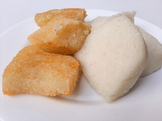 Jadah ketan, is a traditional snack from Indonesia. Made from sticky rice and grated coconut. Comparison before and after fried. On a white plate, isolated in white background