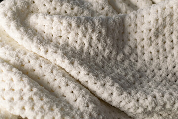 Fine textured and voluminous fabric in white and gray. Embossed textile pattern, pleasant to the touch and delicate, velvety and textured background for design and decoration.