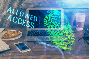 Computer on desktop in office with finger print drawing. Double exposure. Concept of business data security.