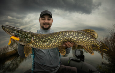  Fishing. Fisherman and trophy Pike.