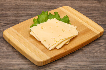 Sliced yellow cheese over board