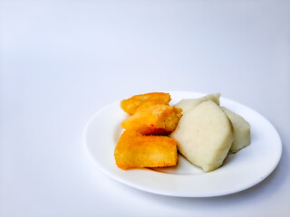 Jadah ketan, is a traditional snack from Indonesia. Made from sticky rice and grated coconut. Comparison before and after fried. On a white plate, isolated in white background