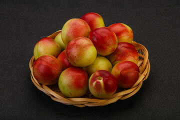 Sweet small nectarines in the basket