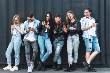 Fototapeta premium Group of young and stylish people using smartphones
