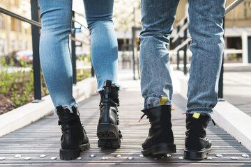 Young stylish couple walking by the road