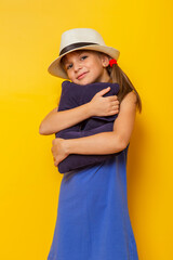 Child hugging a travel pillow