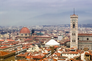 Obraz premium Florence, Italy. A birds eye view of the city landscape toward the cathedral shot from the Arnolfo's tower in the Palazzo Vecchio. Cappella dei principi is visible near the cathedral