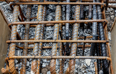 Rebar tie wire work at construction site. Steel bars reinforcing for reinforced concrete and building structures.