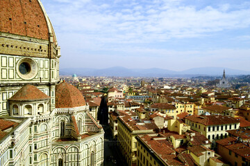Fototapeta na wymiar Florence, Italy. 2015. Aerial view of the city landscape from the belltower of the Duomo Santa Maria del Fiore with its great dome in foreground