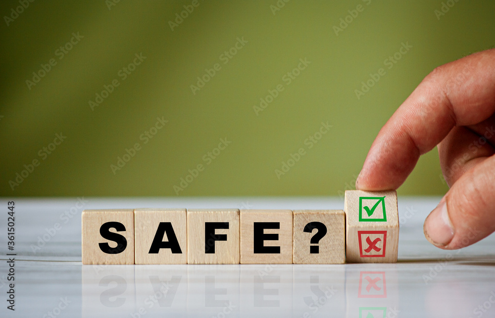 Poster the hand turns the wooden cube and changes the word question safe with green positive tick check box
