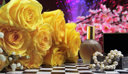 Yellow Flowers With Perfume and Jewelry on Vintage Table