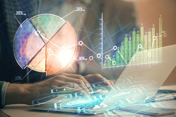 Double exposure of market chart with man working on computer on background. Concept of financial analysis.