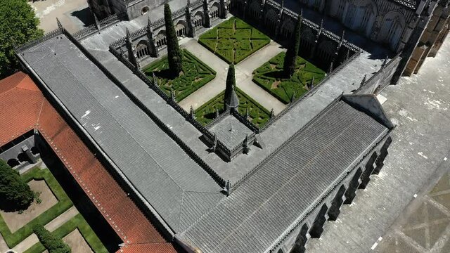Batalha, Portugal - June, 29, 2020: Aerial drone view of Batalha Monastery. Upward reveal camera movement. Dominican convent with manueline style and Medieval architecture in Portugal.
