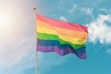 Rainbow LGBT pride flag on a sunny summer day.