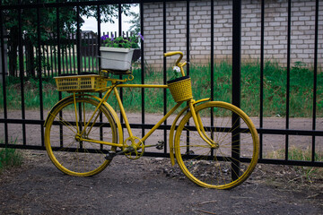 Yellow bike used as a flowerbed, bright summer design
