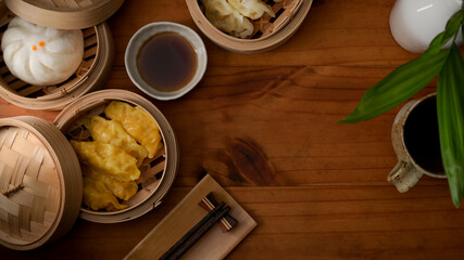 Top view of steamed dumplings serving on bamboo seamer on wooden table