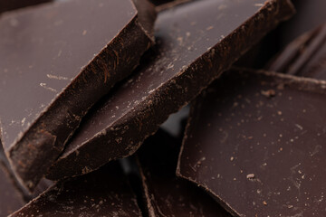 Dark chocolate cracked pieces closeup macro