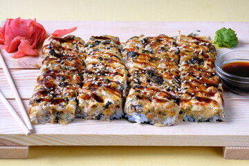 Japanese baked sushi pizza with, snow crab, cheese, wasabi, soy sauce and marinated ginger. Restaurant or cafe menu images.