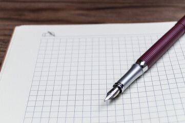 Open daily planner on wooden background. Copyspace template and branding mockup.