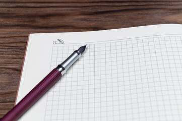 Open daily planner on wooden background. Copyspace template and branding mockup.