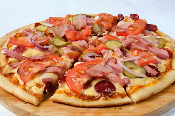 Tasty sliced Pizza with mozzarella, tomatoes, onion   and sausages. Delicious Italian food. Cafe, pizzeria and restaurant menu.