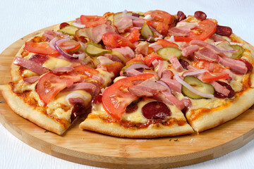 Tasty sliced Pizza with mozzarella, tomatoes, onion   and sausages. Delicious Italian food. Cafe, pizzeria and restaurant menu.