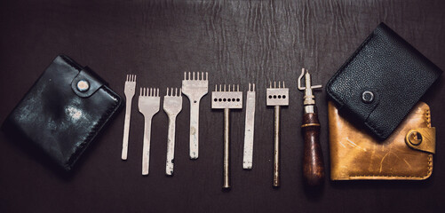 Tanner tools. A leather craftsman makes leather wallets. Men's wallets and tools. Tanner business.