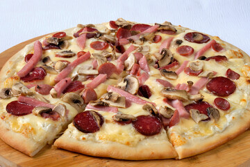 Pizza with mushrooms, mozzarella  and sausages. Delicious Italian food. Cafe, pizzeria and restaurant menu. 