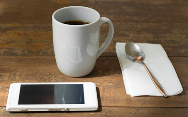 Fototapeta na wymiar Portrait of phone and coffee on wooden table