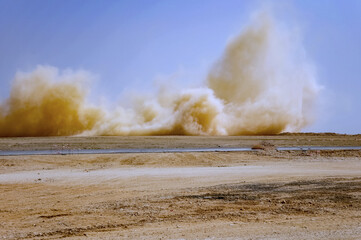 Dust storm after detonator blasting in the Arabian desert 