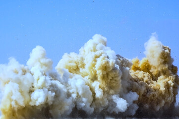 Close up of dust fume of rock after detonator blast in the Arabian desert 